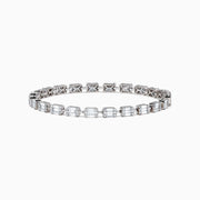 The 14K White Gold Diamond Tennis Bracelet features a row of emerald-cut diamonds set in a sleek 14K white gold band, displayed on a plain white background.