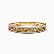 The 14K Yellow Gold Multi Color Diamond Bangle showcases a row of round yellow, orange, and brown diamonds bordered by small white diamonds along the edges.