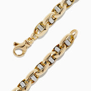 The 14K Two Tone Gold 9 Mariner Link Bracelet features interlocking mariner links with silver accents, crafted in 14K gold and displayed in a circular shape on a plain white background.