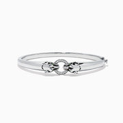 The Signature Sterling Silver Diamond and Tsavorite Panther Bangle, 0.10 TCW, features a sleek design with a central panther motif set with diamonds and tsavorites for a luxurious touch.