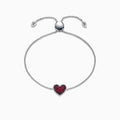 The 925 Sterling Silver Ruby Heart Bracelet, 0.62 TCW, features an adjustable clasp and a central heart-shaped charm accented with red stones. Small heart details at the ends add a touch of elegance to this beautiful piece.