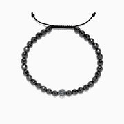 The Mens Sterling Silver Beaded Hematite Anchor Bracelet, 81.00 TCW, features shiny black hematite round beads and an adjustable black cord, with a patterned Effy sterling silver bead centered among the beads. Displayed on a white background.
