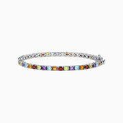 The Mosaic Sterling Silver Multi Gemstone Tennis Bracelet, 9.10 TCW, showcases alternating square and round gemstones in purple, red, yellow, blue, and orange against a white background.