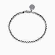 The Mens Sterling Silver 8 Box Link Bracelet features a round blank charm near the clasp and is displayed against a white background.