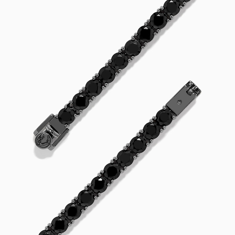 The Mens Silver Rhodium Plated Black Spinel Tennis Bracelet features a row of round black spinels in a sleek silver band, shown on a white background.