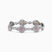 18K two-tone gold bracelet featuring GIA certified pink diamonds (5.39 TCW) in oval and marquise shapes, accented by small clear stones and detailed filigree on the sides.