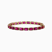 A 14K yellow gold bracelet set with rubies and diamonds, totaling 14.97 TCW, arranged in an elegant tennis style.
