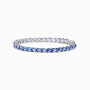 The 925 Sterling Silver Tanzanite Bracelet features a continuous row of marquise-cut tanzanite gemstones totaling 10.00 TCW, set in sterling silver for an elegant look.