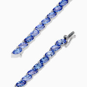 The 925 Sterling Silver Tanzanite Bracelet features a continuous row of marquise-cut tanzanite gemstones totaling 10.00 TCW, set in sterling silver for an elegant look.