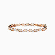 The Aurora 14K Rose Gold Opal Tennis Bracelet, 4.72 TCW, showcases round white opals set in a continuous line along a rose gold band for an elegant look.