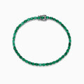 The 925 Sterling Silver Emerald Tennis Bracelet, 6.99 TCW, features a single row of round-cut green gemstones set in sterling silver with a secure clasp, shown elegantly on a white background.