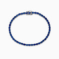The 925 Sterling Silver Blue Sapphire Tennis Bracelet, 6.99 TCW, features evenly spaced round blue sapphires set in a slender sterling silver band and is finished with a secure clasp.