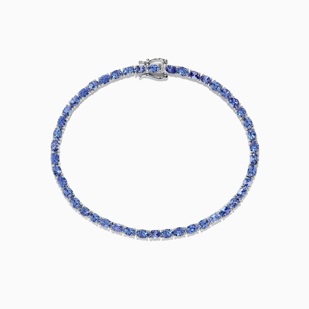 The Nahla Siri Sterling Silver Tanzanite Tennis Bracelet, 6.65 TCW, features oval-cut blue stones in a circular design, set in elegant sterling silver and shown on a white background.