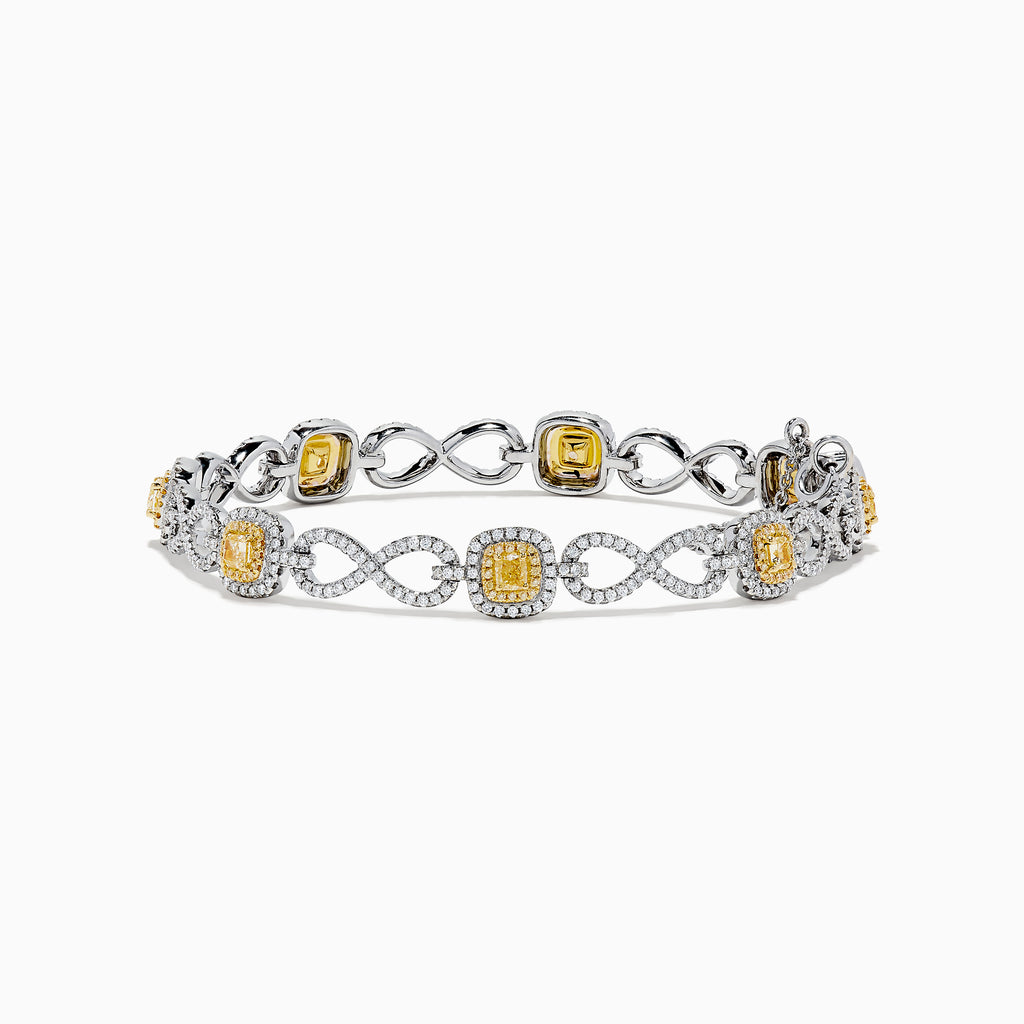 The Canare 14K Two Tone Gold Yellow and White Diamond Infinity Tennis Bracelet, 3.34 TCW, features an intricate infinity pattern set with yellow gemstones framed by diamonds and a secure right-side clasp.
