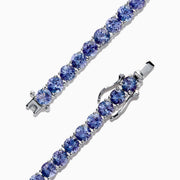 The Nahla Siri Sterling Silver Tanzanite Tennis Bracelet, 15.60 TCW, features a single row of round tanzanite gemstones set in prongs, shown on a white background.