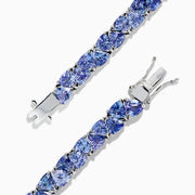 The Nahla Siri Sterling Silver Tanzanite Tennis Bracelet, 18.62 TCW, features a row of square-cut tanzanite gemstones in individual prongs and a secure clasp for an elegant, polished look.