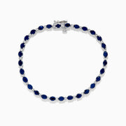 The 925 Sterling Silver Blue Sapphire Tennis Bracelet features a continuous row of oval blue sapphires set in prongs with a secure clasp.