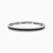 The 14K White Gold Black and White Diamond Bangle, 3.93 TCW, showcases a row of black diamonds at the center with intricate edge detailing, presented against a white background.