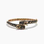 The Safari 14K Yellow Gold Black Diamond Dragon Bangle showcases a detailed dragon design with black scale patterns and gold accents, featuring the dragon’s head and claws as the clasp for a bold, mythical touch.