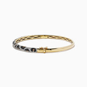 A 14K yellow gold bangle showcases panther spots with black, espresso, and white diamonds totaling 1.48 TCW for a dazzling, patterned look.