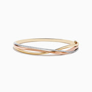 The Trio 14K Three-Tone Gold Diamond Bangle 0.29 TCW features intertwined bands of yellow, rose, and white gold with a row of sparkling diamonds on one band, shown against a white background.