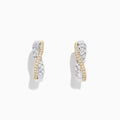 A pair of 14K White and Yellow Gold 3/4 Diamond Crossover Hoop Earrings (1.00 TCW) featuring a curved design with silver and gold tones, sparkling with encrusted diamonds against a plain white background.