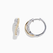A pair of 14K White and Yellow Gold 3/4 Diamond Crossover Hoop Earrings (1.00 TCW) featuring a curved design with silver and gold tones, sparkling with encrusted diamonds against a plain white background.