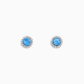 Ocean Bleu 14K White Gold Blue Topaz and Diamond Earrings, 1.32 TCW, feature round blue topaz center stones encircled by sparkling diamonds in a circular white gold setting on a white background.