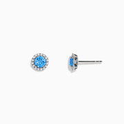 Ocean Bleu 14K White Gold Blue Topaz and Diamond Earrings, 1.32 TCW, feature round blue topaz center stones encircled by sparkling diamonds in a circular white gold setting on a white background.