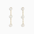 The 14K Yellow Gold Cultured Fresh Water Pearl Drop Earrings feature three round pearls on each earring, linked by delicate gold chains and shown against a white background.