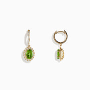 The 14K Yellow Gold Peridot and Diamond Earrings feature oval green peridot gemstones surrounded by sparkling diamonds, each hanging from a diamond-studded bar, shown on a white background.