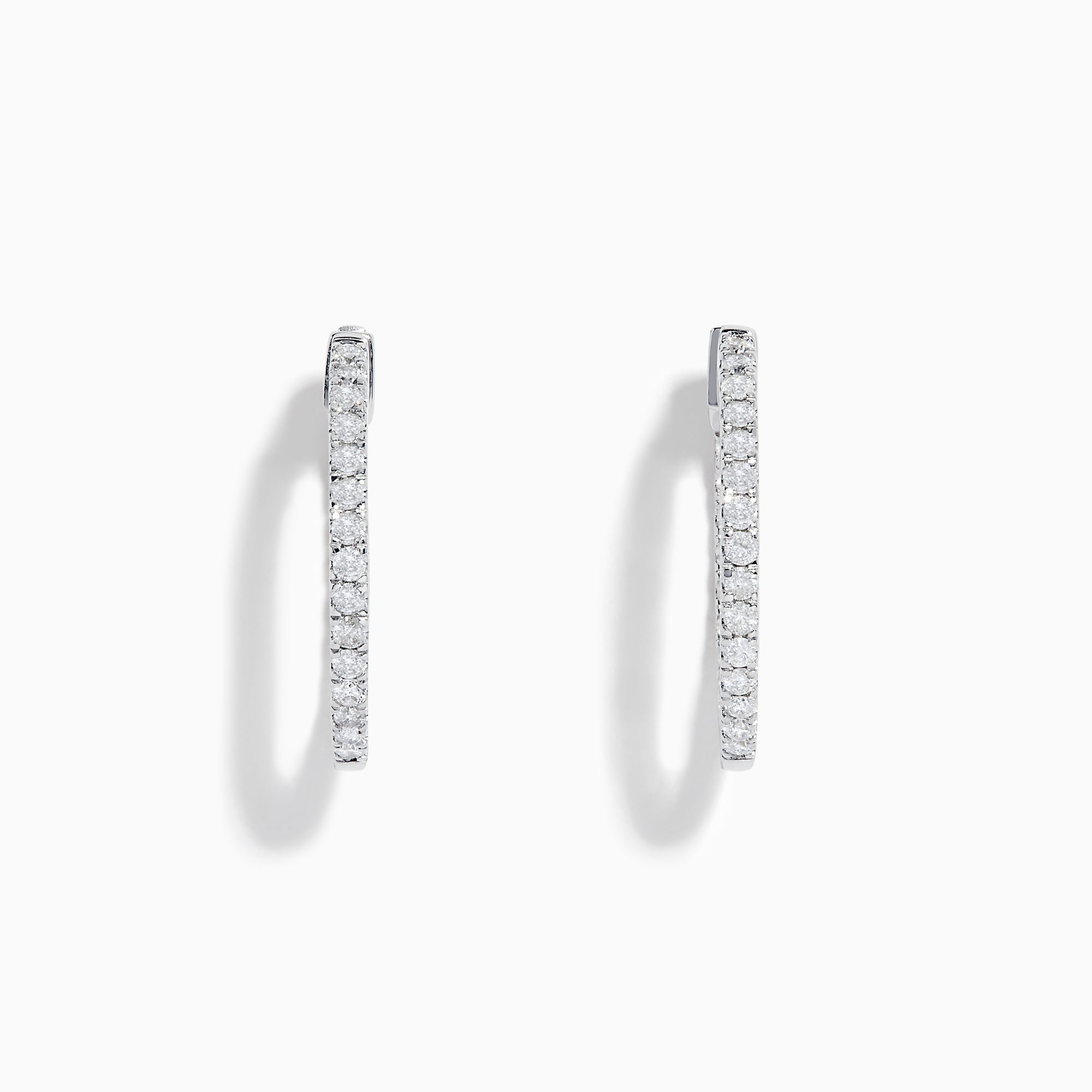 A pair of 14K White Gold 3/4 Diamond Hoop Earrings, thin and encrusted with sparkling diamonds, displayed vertically on a white background with soft shadows.