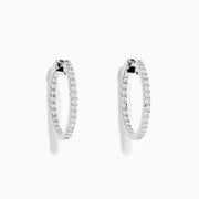 A pair of 14K White Gold 3/4 Diamond Hoop Earrings, thin and encrusted with sparkling diamonds, displayed vertically on a white background with soft shadows.