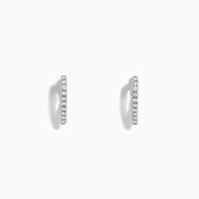 Pave Classica 14K White Gold Diamond Huggie Earrings, 0.22 TCW, are small, thin earrings encrusted with diamonds and shown on a white background with soft shadows.