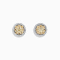 The Canare 14K Two Tone Gold Yellow Diamond Bouquet Halo Earrings feature a classic round design with a yellow diamond center and a halo of clear stones, totaling 0.98 carats.