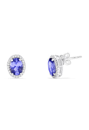 A pair of 14K white gold tanzanite and diamond stud earrings, 2.20 TCW, featuring vibrant oval blue tanzanites each encircled by sparkling diamonds.