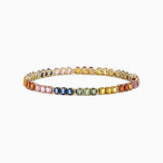 The Watercolors 14K Gold Multi Sapphire & Diamond Tennis Bracelet, 9.73 TW, features a gradient rainbow of oval-cut sapphires and sparkling diamonds, displayed on a white background.