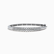 The 925 Sterling Silver Diamond Bangle, 0.50 TCW, features a central section adorned with sparkling diamonds and is displayed against a plain white background.