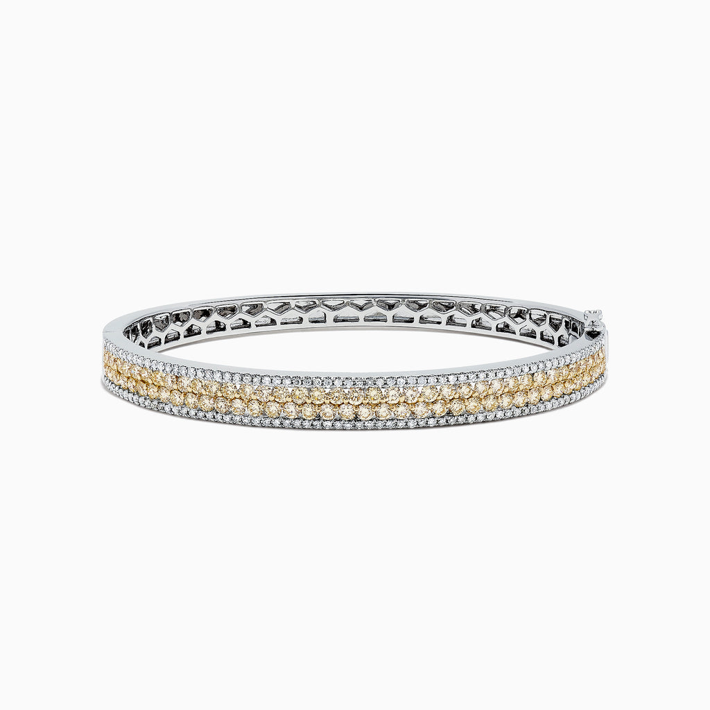 The Canare 14K Gold Yellow and White Diamond Bangle, 3.40 TCW, showcases a central row of yellow and white diamonds in an elegant geometric design inspired by Effy—an eye-catching gold statement piece.
