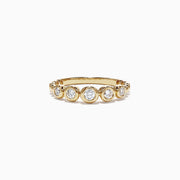 The DOro 14K Yellow Gold Bezel Set Diamond Ring showcases a row of round diamonds totaling 0.33 TCW, evenly spaced around the band and displayed on a white background.
