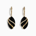 The Eclipse 14K Yellow Gold Onyx and Diamond Drop Earrings, 11.53 TCW, feature oval black onyx stones wrapped in gold with sparkling diamond accents, and yellow gold hooks adorned with white gemstones.