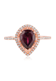 The Bordeaux 14K Rose Gold Rhodolite Garnet and Diamond Ring (1.46 TCW) features a pear-shaped rhodolite garnet center, surrounded by a halo of white diamonds with additional diamond accents on the band.