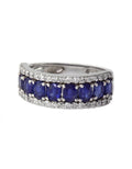 The Gemma White Gold Blue Sapphire & Diamond Ring, 2.61 TCW, features deep blue sapphires accented by sparkling diamonds in a curved white gold band, elegantly displayed against a white background.