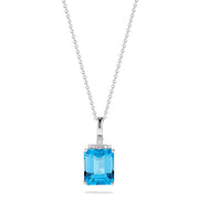 A 14K white gold pendant featuring an 8.48 TCW rectangular blue topaz and sparkling diamond accents on the bail, capturing the brilliance of a classic diamond pendant.