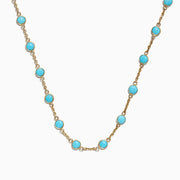 The 14K Yellow Gold Turquoise Necklace, 7.75 TCW, showcases evenly spaced round turquoise stones set in yellow gold bezels, displayed on a white background.