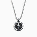 A Mens Sterling Silver Onyx Compass Pendant, 4.00 TCW, featuring a round design is shown on a silver chain and photographed on a white background.
