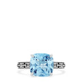 The 925 Sterling Silver Blue Topaz Ring, 5.20 TCW, features a square-cut light blue gemstone and geometric black engravings along the band, offering a modern and elegant style.