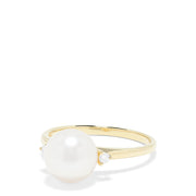 The 14K Yellow Gold Cultured Pearl and Diamond Accented Ring, 0.05 TCW, features a large round cultured pearl at the center with diamond accents on each side, shown on a plain white background.
