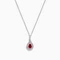 The Ruby Royale 14K Two Tone Gold Pear Shaped Ruby Pendant (0.68 TCW) features a stunning ruby, accented by small clear stones, showcased on a white background.