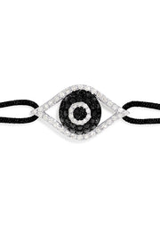 The Novelty White Gold Black & White Diamond Evil Eye Bracelet, 0.43 TCW, features an eye-shaped charm with a central black stone and clear accents on a black adjustable cord with sliding knots for easy sizing.